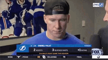 a man wearing a baseball cap and a blue shirt is on a fox sports channel