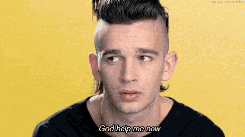 a man with a mullet and a black shirt says god help me now