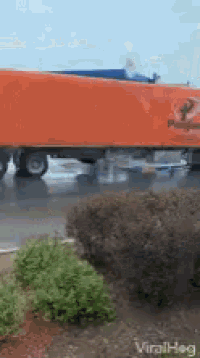 a large orange truck with the letter p on it