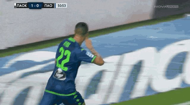 a soccer player wearing a blue and green jersey with the number 22 on it