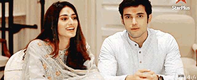 a man and a woman are sitting at a table with a starplus logo in the corner