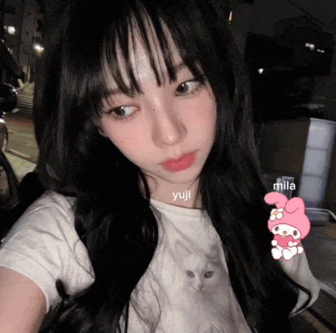 a girl with long black hair is wearing a white shirt with a white cat on it