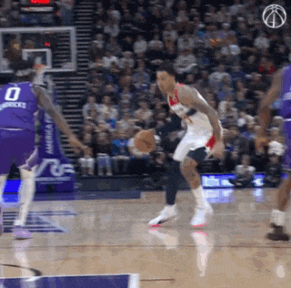 a basketball player wearing a number 0 jersey dribbles the ball