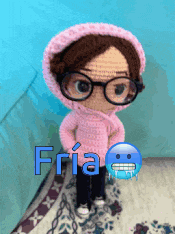 a doll wearing glasses and a pink sweater with the word fria written on it