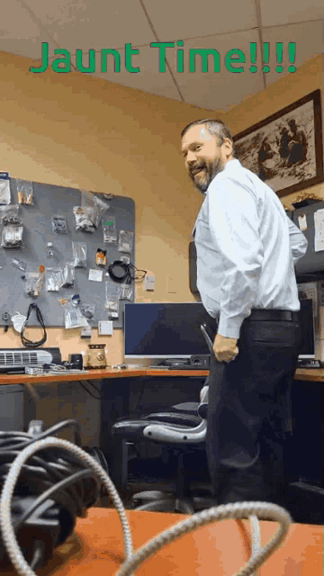 a man in a white shirt is standing in front of a desk with the words jaunt time written above him