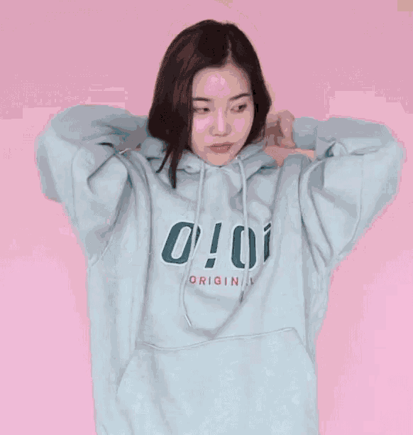 a woman wearing a hoodie that says o ! oi originals