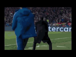 a man dancing on a soccer field in front of a ps4 logo