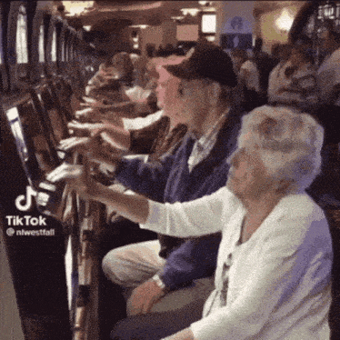 a couple of elderly people playing a slot machine with tiktok written on the bottom right