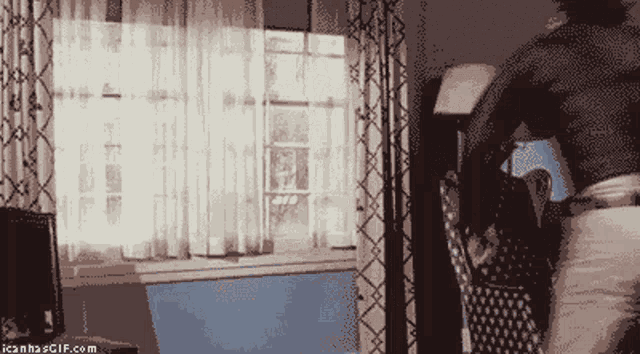a pixelated image of a living room with the website icanhaegif.com in the lower right corner