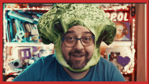 a man wearing a cabbage hat with the word pol on the bottom right