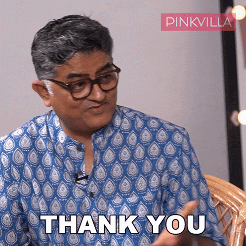 a man wearing glasses and a blue shirt says " thank you "
