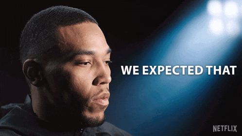 a man says we expected that in front of a blue background