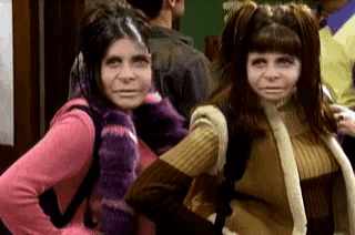 two girls with pigtails are posing for a picture with their hands on their hips