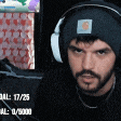 a man wearing headphones and a beanie is looking at the camera