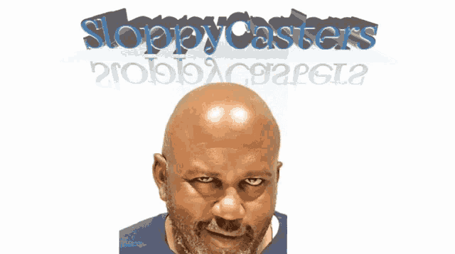 a bald man with a beard stands in front of a sloppy casters sign
