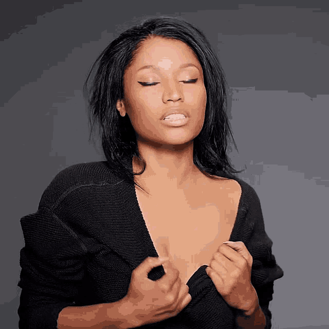 a woman with her eyes closed and her sweater open