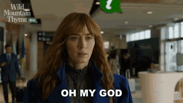 a woman says oh my god in front of a wild mountain thyme sign