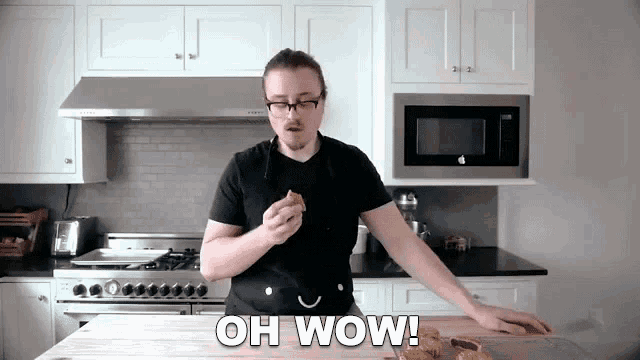 a man in a kitchen with the words oh wow written on the bottom