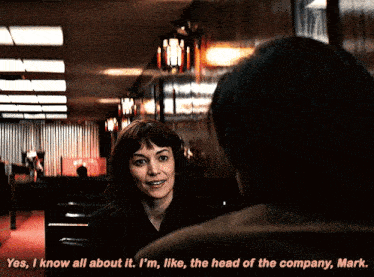 a woman talks to a man in a dark room and says " yes i know all about it