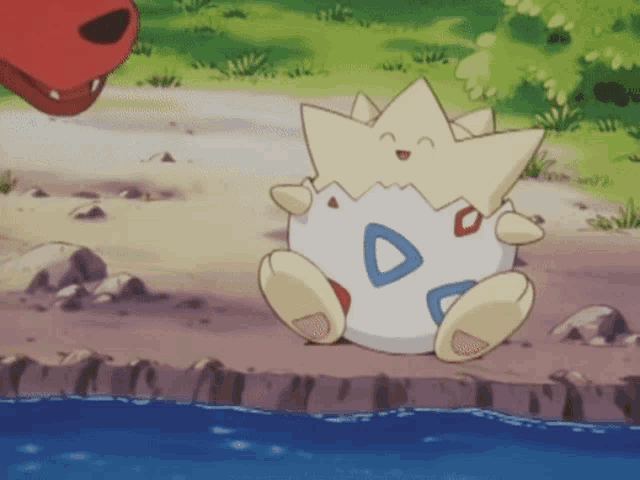 a cartoon character with a star on its head is sitting on the ground