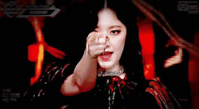 a woman 's face is shown in front of a screen that says ' mnet ' on it