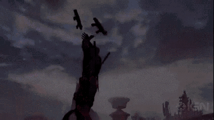 a silhouette of a man holding a gun in the air .