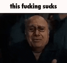 a man with a sad look on his face is making a funny face .