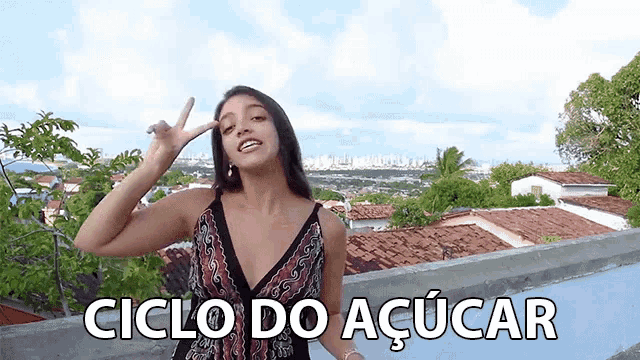 a woman giving a peace sign with the words ciclo do açucar written below her