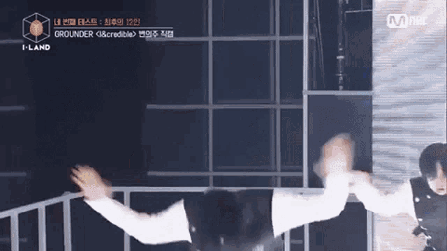 a person is flying through the air on a stage in front of a mnet logo .