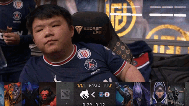 a man sits in a chair that says secret lab on the back
