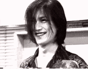 a black and white photo of a smiling man