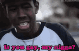a close up of a man 's face with the words is you gay my nigga written on it