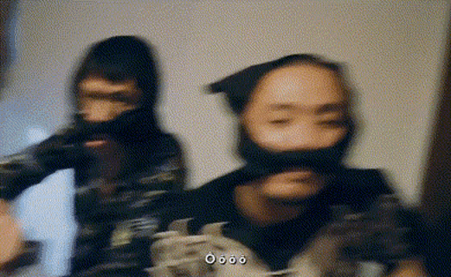 a blurry picture of a man wearing a mask and a beard .