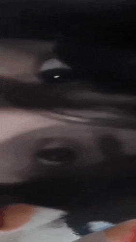 a blurry picture of a person 's face with a blurred background