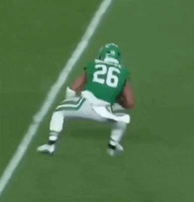 a football player with the number 3 on his jersey is being tackled by another player
