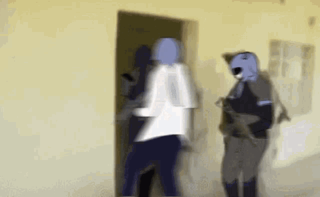 a blurry picture of a group of people standing next to each other in a room .