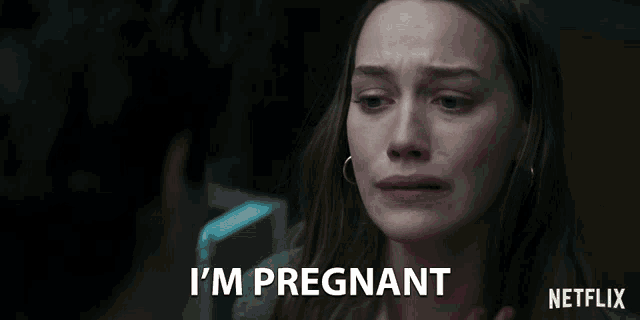a woman says i 'm pregnant in front of a netflix logo