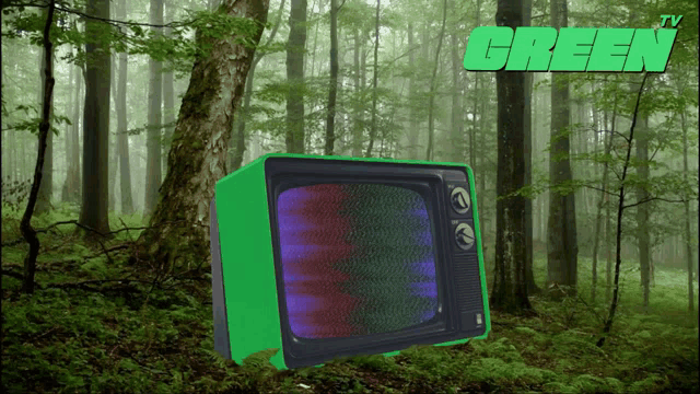 a green tv is sitting in the middle of a forest with a green tv logo above it