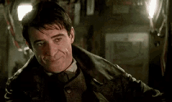 a man in a leather jacket and tie is smiling .
