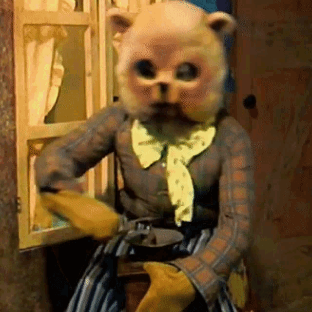 a teddy bear is sitting in front of a window wearing gloves