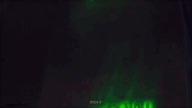 a man smoking a cigarette in front of a building with the word morir written below him