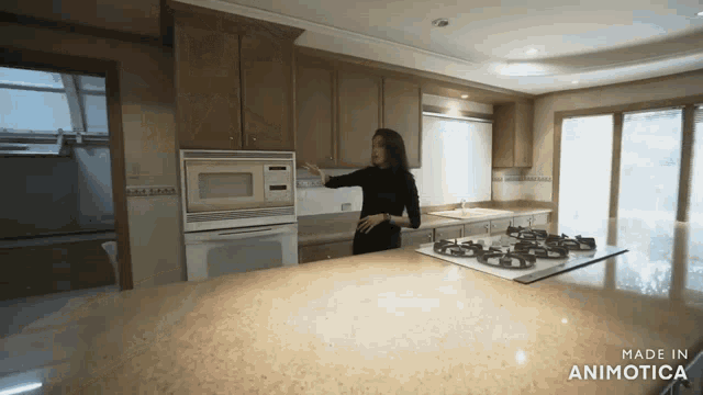 a woman in a kitchen with the words made in animotica on the bottom right