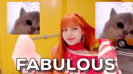 a woman with red hair is holding cotton candy in front of a yellow wall and a dog .