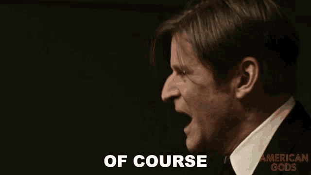 a close up of a man screaming with the words of course in the background