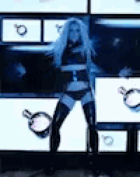 a woman in thigh high boots is standing in front of a wall of signs .
