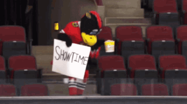 a mascot holding a sign that says showtime on it
