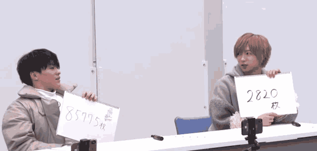 a man is throwing a piece of paper at another man