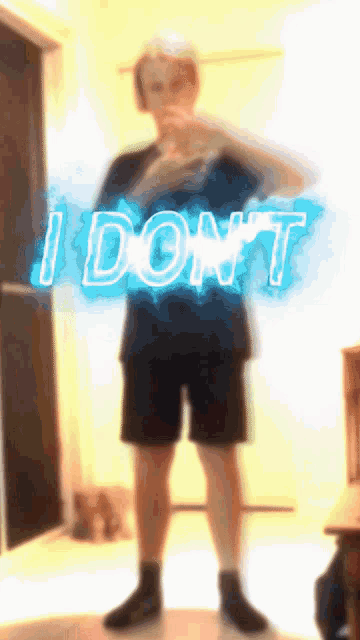 a person standing in front of a neon sign that says i don t