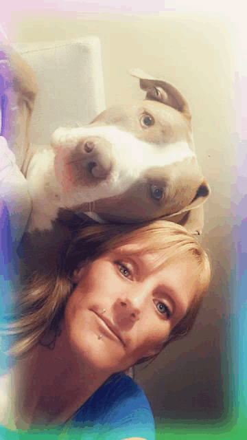 a woman and her dog are posing for a photo