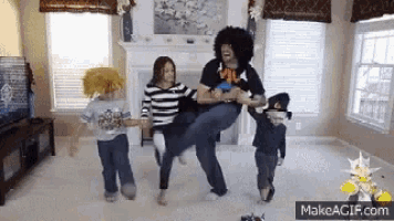 a group of people are dancing in a living room with makeagif.com in the lower right corner